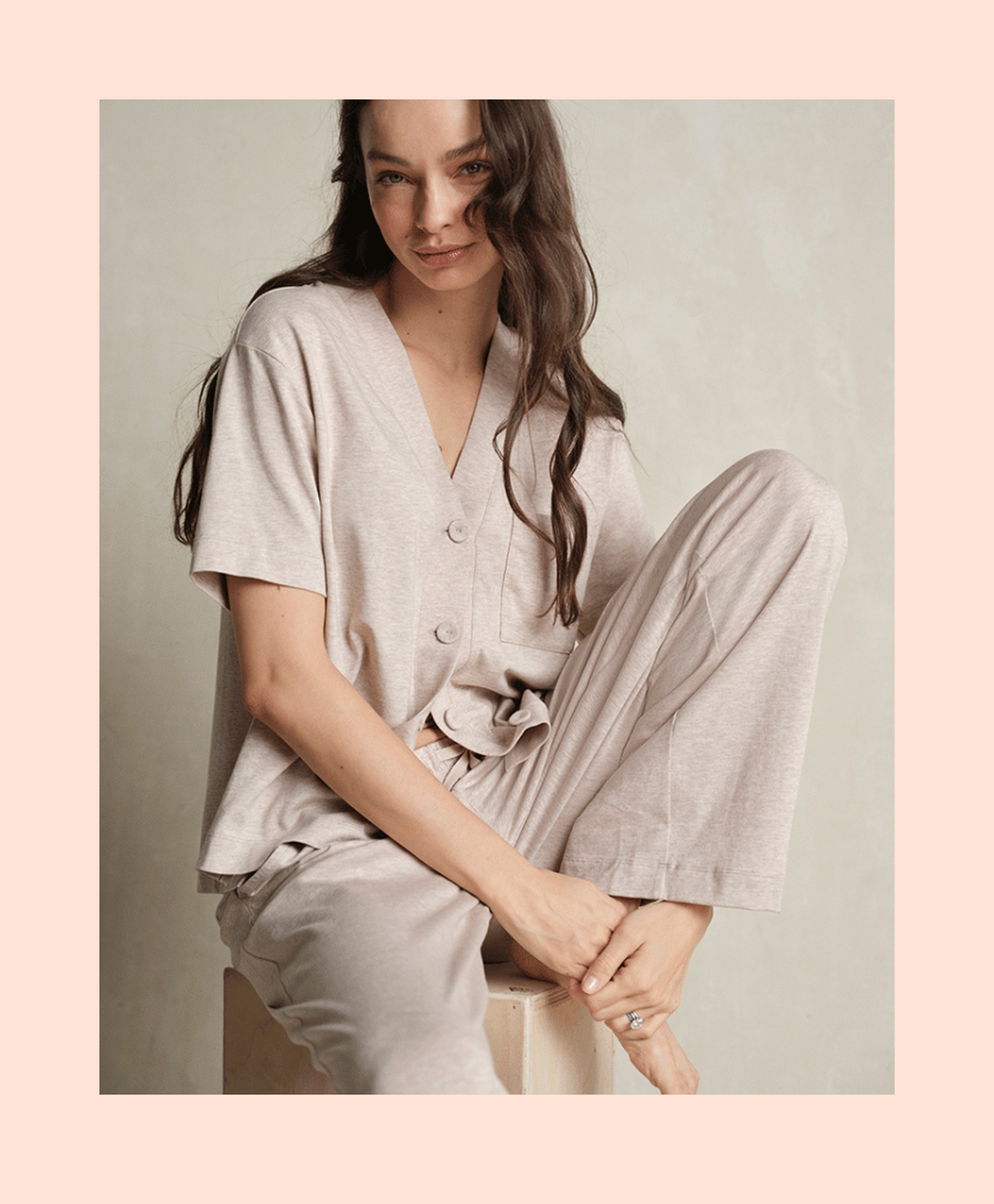 Woman wearing beige pajama set sitting comfortably